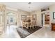 Bright dining room features a chandelier and ample space for entertaining at 17112 Se 71St Lewisfield Ter, The Villages, FL 32162