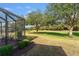 View of lush golf course from screened patio at 17112 Se 71St Lewisfield Ter, The Villages, FL 32162