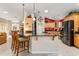 Sleek kitchen island with granite countertop and breakfast bar at 17112 Se 71St Lewisfield Ter, The Villages, FL 32162
