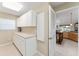 Laundry room with cabinets and access to kitchen at 17112 Se 71St Lewisfield Ter, The Villages, FL 32162