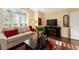 Living room with fireplace, large windows, and comfortable seating at 17112 Se 71St Lewisfield Ter, The Villages, FL 32162
