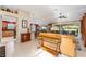 Spacious living room with a tan couch and view of the backyard at 17112 Se 71St Lewisfield Ter, The Villages, FL 32162