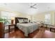 Large bedroom with a king-size bed and hardwood floors at 17112 Se 71St Lewisfield Ter, The Villages, FL 32162