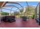 Relaxing screened lanai with hot tub and seating area at 17112 Se 71St Lewisfield Ter, The Villages, FL 32162