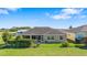 Backyard featuring green lawn, landscaping and a screened-in patio at 17350 Se 116Th Court Rd, Summerfield, FL 34491