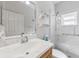 Clean bathroom featuring walk-in shower with marble surround and granite countertop at 17350 Se 116Th Court Rd, Summerfield, FL 34491