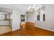 Dining room with hardwood floors, chandelier, and view into modern kitchen at 17350 Se 116Th Court Rd, Summerfield, FL 34491