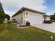 Exterior of house showing garage and landscaping at 17350 Se 116Th Court Rd, Summerfield, FL 34491