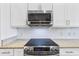 Modern kitchen showcasing stainless steel appliances, subway tile backsplash, and granite countertops at 17350 Se 116Th Court Rd, Summerfield, FL 34491
