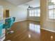 Hardwood floor living room with ceiling fan and access to kitchen at 17350 Se 116Th Court Rd, Summerfield, FL 34491