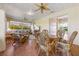 Enclosed patio area with ceiling fans, comfortable seating, and sliding glass doors at 17350 Se 116Th Court Rd, Summerfield, FL 34491