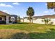 Spacious backyard with screened patio, lush lawn, and privacy fence at 17716 Se 85Th Ellerbe Ave, The Villages, FL 32162