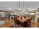 Open dining room with hardwood floors and stylish light fixtures at 17716 Se 85Th Ellerbe Ave, The Villages, FL 32162