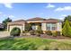 Well-maintained one-story house featuring a two-car garage and lush landscaping at 17716 Se 85Th Ellerbe Ave, The Villages, FL 32162