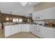 Modern kitchen with white cabinets, granite countertops and stainless steel appliances at 17716 Se 85Th Ellerbe Ave, The Villages, FL 32162