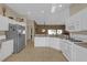 Modern kitchen with white cabinets, granite countertops and stainless steel appliances at 17716 Se 85Th Ellerbe Ave, The Villages, FL 32162