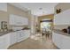 Bright kitchen with white cabinets, granite counters, and breakfast nook at 17716 Se 85Th Ellerbe Ave, The Villages, FL 32162