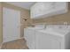 Laundry room with washer, dryer, and storage cabinets at 17716 Se 85Th Ellerbe Ave, The Villages, FL 32162