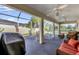 Relaxing screened patio with wicker furniture, ceiling fans and a built-in grill at 17716 Se 85Th Ellerbe Ave, The Villages, FL 32162