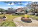 Landscaped backyard with fire pit and house view at 18033 Rose St, Groveland, FL 34736