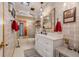 Bathroom features a white vanity, subway tile, and a shower/tub combo at 18033 Rose St, Groveland, FL 34736