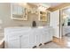 Bathroom featuring a double vanity and mirrors with a closet and tile flooring at 18033 Rose St, Groveland, FL 34736
