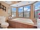 Bathroom with a large garden tub and tile flooring at 18033 Rose St, Groveland, FL 34736
