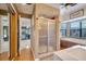 Bathroom with shower, garden tub, and access to the pool at 18033 Rose St, Groveland, FL 34736