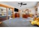 Main bedroom with mirrored closet doors and a large TV at 18033 Rose St, Groveland, FL 34736