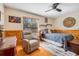 Cozy bedroom with wood-paneled walls and a comfortable recliner at 18033 Rose St, Groveland, FL 34736