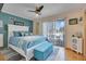 Main bedroom with a king-size bed and access to a balcony at 18033 Rose St, Groveland, FL 34736