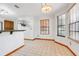 Bright breakfast nook with tile floor and a chandelier with views from multiple windows at 18033 Rose St, Groveland, FL 34736