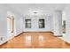 Spacious dining area with hardwood floors, modern lighting, and large windows at 18033 Rose St, Groveland, FL 34736
