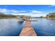 Private dock extending over calm lake water with covered seating area at 18033 Rose St, Groveland, FL 34736