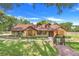Charming single-story home features manicured lawn and lush landscaping at 18033 Rose St, Groveland, FL 34736