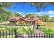 Charming single-story home features manicured lawn and lush landscaping at 18033 Rose St, Groveland, FL 34736