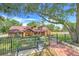 Inviting home with a well-maintained lawn, brick walkway, and a charming front bench at 18033 Rose St, Groveland, FL 34736