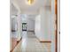 Bright hallway with tile flooring leads to open living space with vaulted ceilings and natural light at 18033 Rose St, Groveland, FL 34736