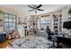Home office with built-in shelving, desk, and comfortable seating at 18033 Rose St, Groveland, FL 34736