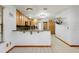 Kitchen features a bar, stainless steel appliances, a tile floor, and wood cabinets at 18033 Rose St, Groveland, FL 34736