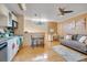 Eat-in kitchen with light wood floors, white cabinets and a sofa at 18033 Rose St, Groveland, FL 34736