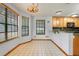 Dining area with large windows, a chandelier and pendant lights, and lots of natural light at 18033 Rose St, Groveland, FL 34736