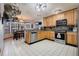 Kitchen with wood cabinets, stainless steel appliances, and tile floor at 18033 Rose St, Groveland, FL 34736