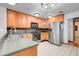 Kitchen features stainless steel appliances, wooden cabinets, and tile backsplash at 18033 Rose St, Groveland, FL 34736