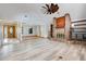 Open floor plan featuring a living room with a brick fireplace and an adjacent dining area at 18033 Rose St, Groveland, FL 34736