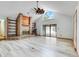 Cozy living room featuring a brick fireplace, built-in shelving, and access to the outdoor lanai at 18033 Rose St, Groveland, FL 34736