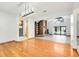 Open living space with hardwood floors, brick fireplace, and access to the outdoor pool area at 18033 Rose St, Groveland, FL 34736