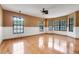 Versatile living space featuring hardwood floors, large windows, and ample natural light at 18033 Rose St, Groveland, FL 34736