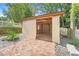 Outdoor storage shed featuring a brick patio surrounded by lush landscaping at 18033 Rose St, Groveland, FL 34736