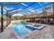 Enclosed pool and spa with a spacious patio area at 18033 Rose St, Groveland, FL 34736